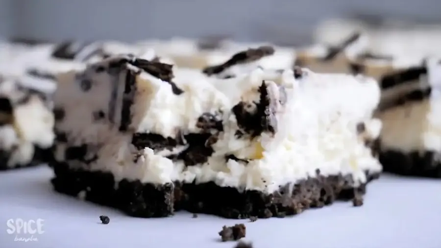 Creamy Oreo cheesecake slice on a white background.