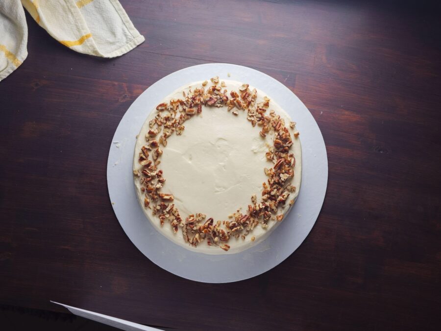 Carrot cake with cream cheese frosting and pecan topping.
