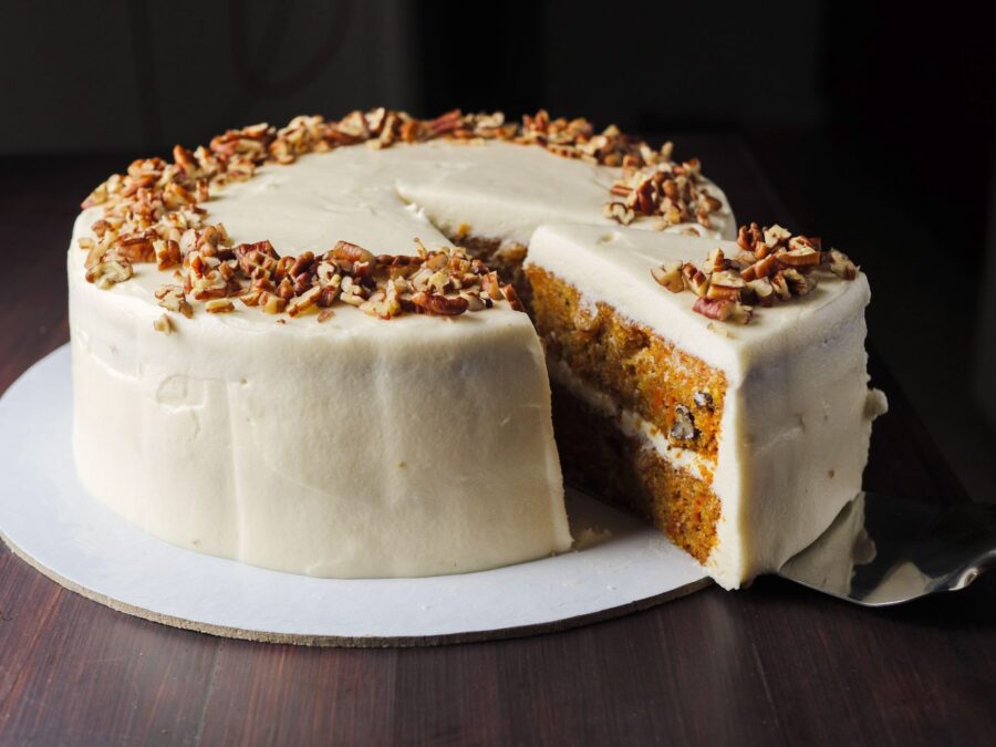 Carrot cake with cream cheese frosting and pecan topping.