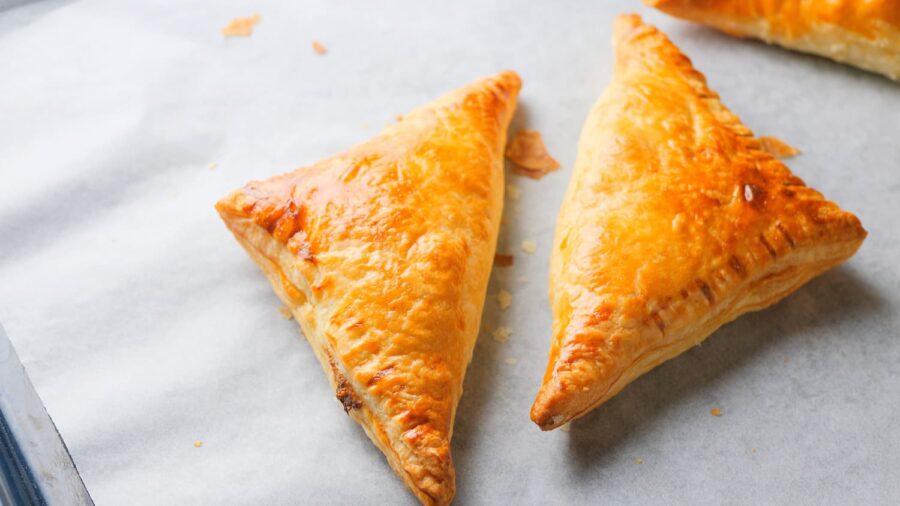 2 pieces of chicken puff pastry on a baking tray