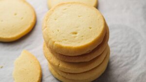 Stack of buttery cookies on parchment paper.