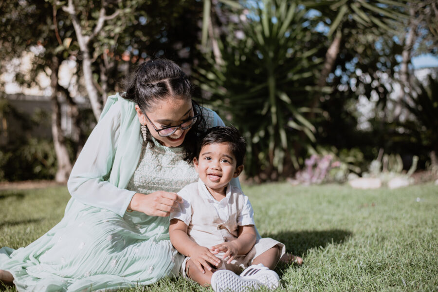 Mother and child laughing together on a sunny day.