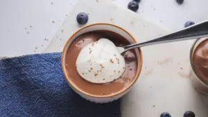 Greek Yogurt Chocolate Pudding in a ramekin with a spoon in it