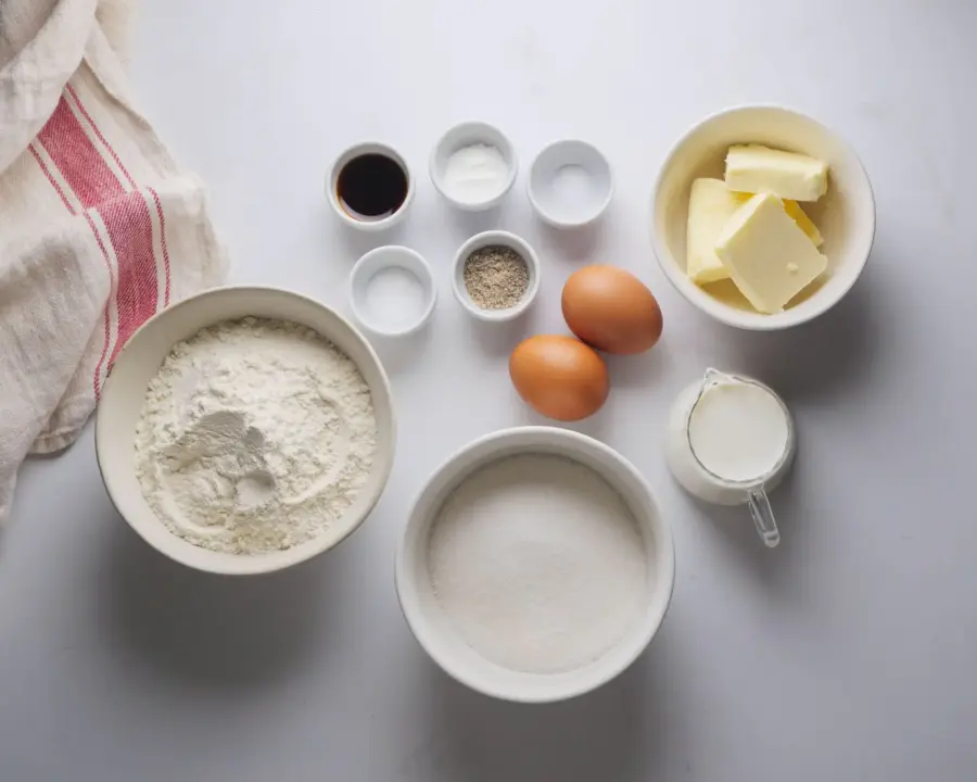 Cardamom Cake Recipe Ingredients on a kitchen table surface