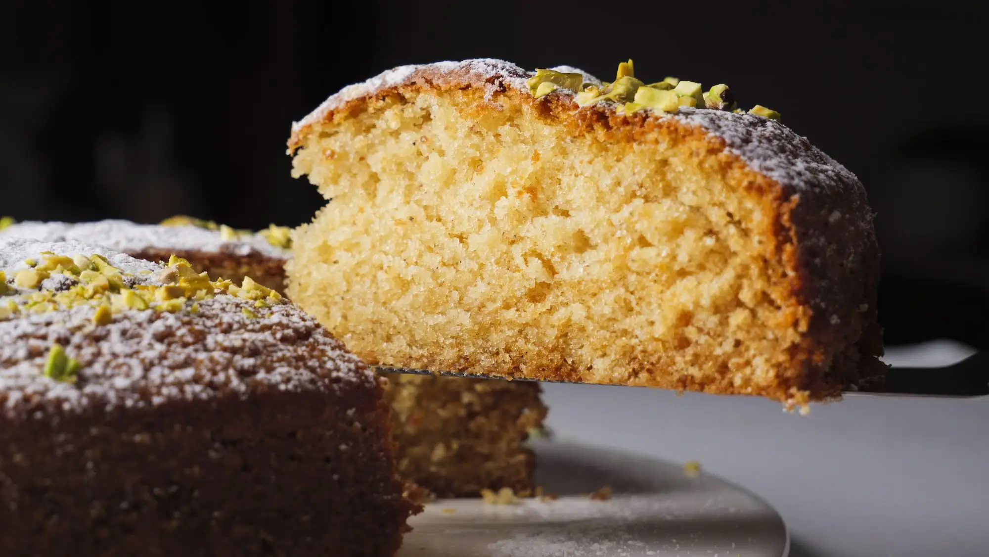 Cardamom Cake sliced with a knife