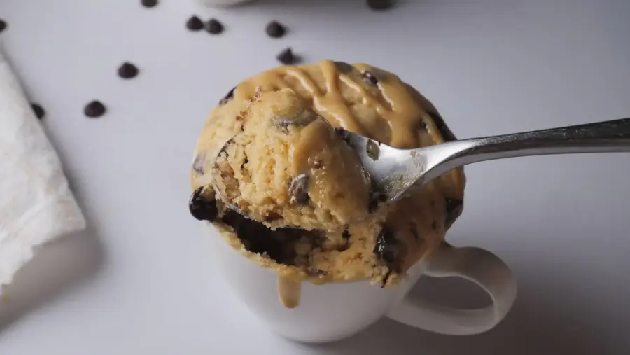 Peanut Butter Mug Cake in a mug with a spoon in it