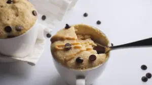 Peanut Butter Mug Cake in a mug with a spoon in it