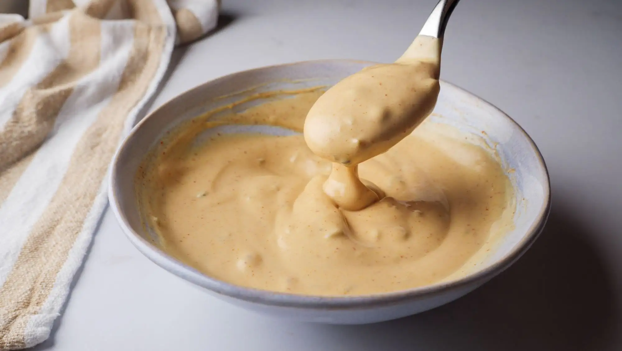 Healthy Big Mac Sauce in a serving bowl with a spoon
