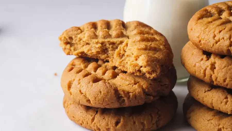 4 Ingredient Peanut Butter Cookies stakes in a serving area with milk