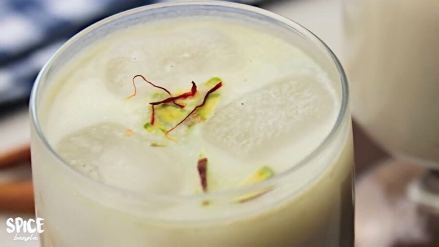 Badam Milk is served with pistachio and saffron in a glass