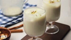 Badam Milk is served with pistachio and saffron in a glassware
