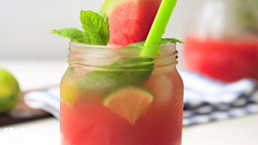 Watermelon Lemonade served in a glass with a slice of watermelon and mint