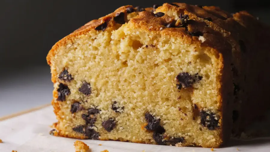 Chocolate Chip Loaf Cake placed on a serving board