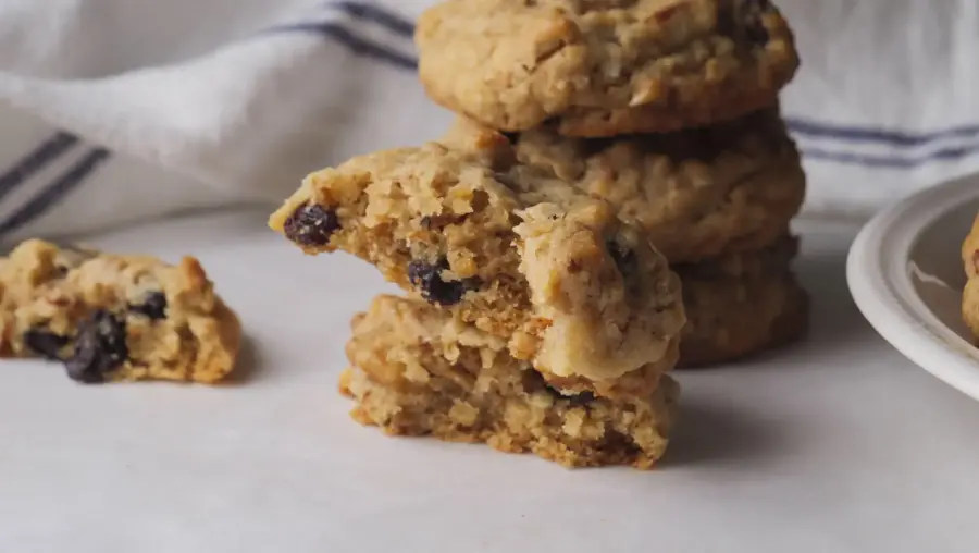 Granola Cookies are served on a serving board, and some are stacked