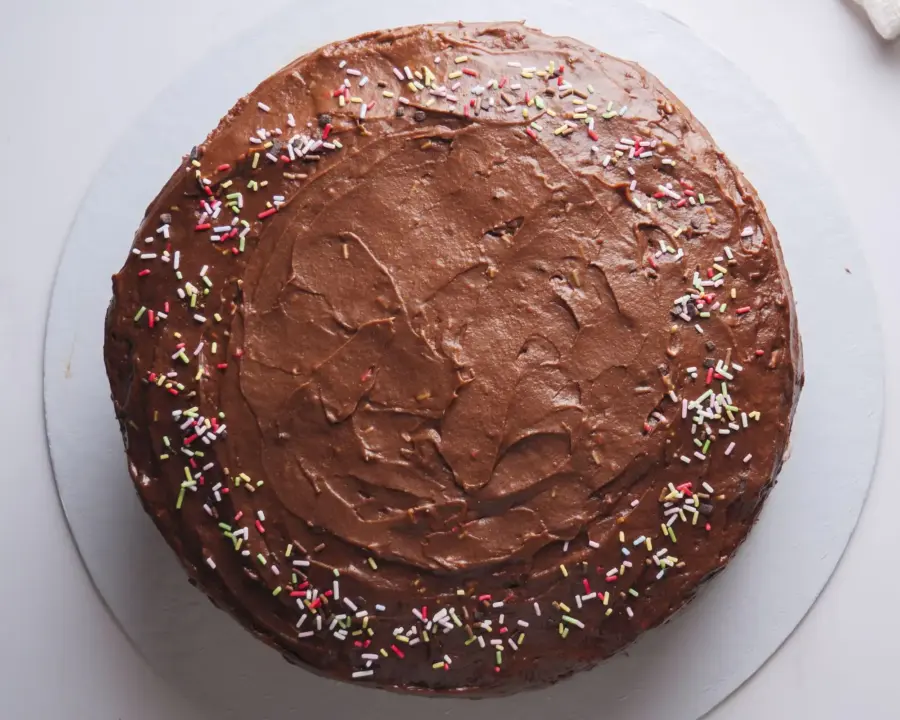 Vanilla Cake with Chocolate Frosting served on a cake board