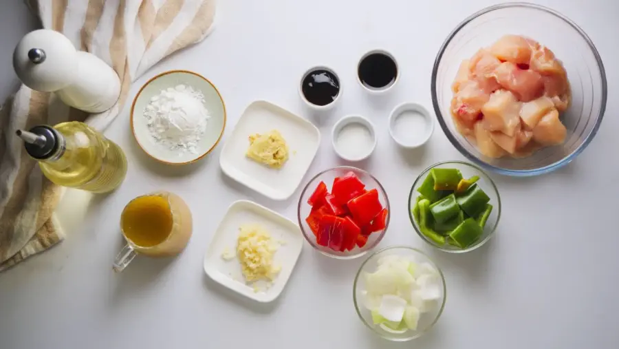 Black Pepper Chicken stir-fry ingredients on a white countertop.