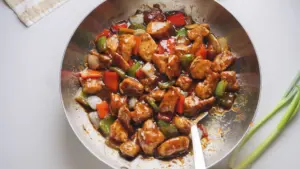 Stir-fried Black Pepper chicken with bell peppers in a savory sauce.
