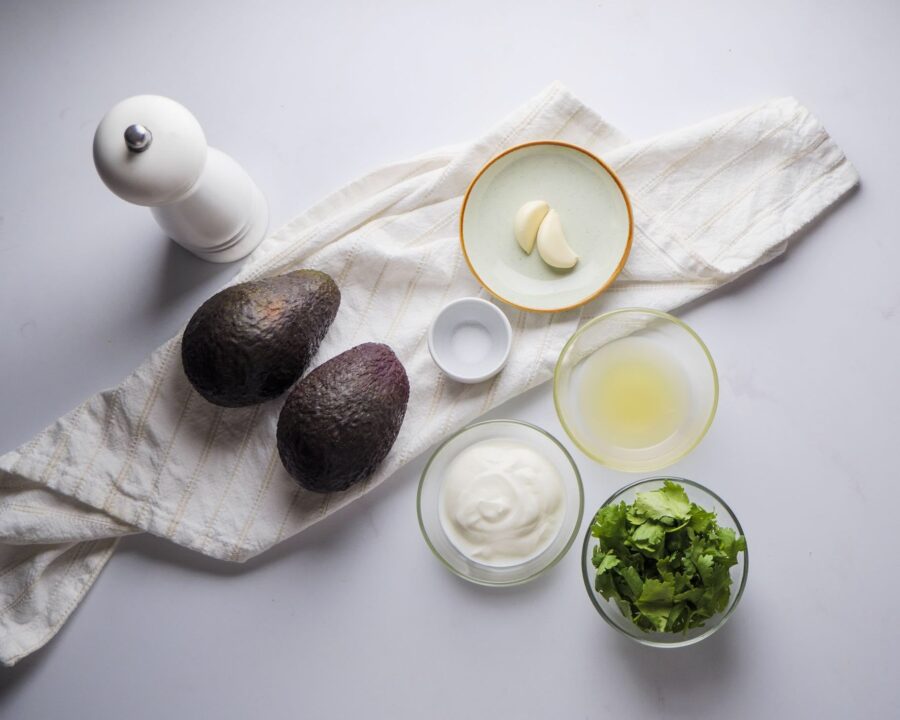 Creamy Avocado Sauce Ingredients placed on a white kitchen counter