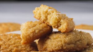 Stack of fresh coconut cookies on a serving plate