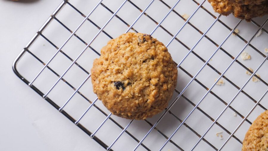Oatmeal cookie cooling on a wire rack.
