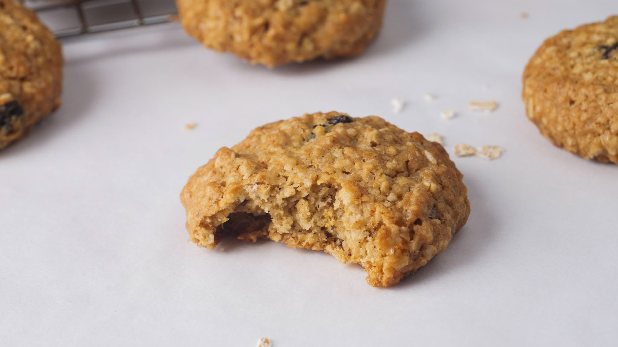 Bite-sized oatmeal cookie on parchment paper.
