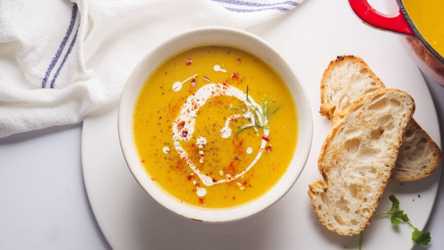 Simple and healthy butternut squash soup in a serving bowl with toasted breads