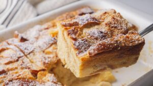 Fresh baked bread pudding served with powdered sugar.
