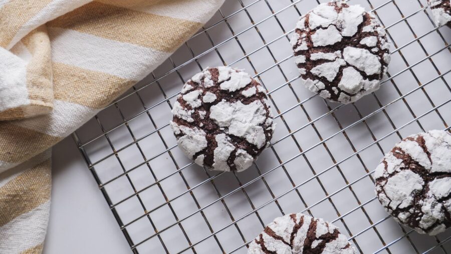Chocolate Crinkle Cookies on a cooling rack.