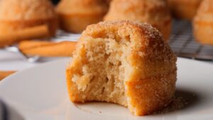 Close up of a sugar-coated Cinnamon muffin with a bite taken.
