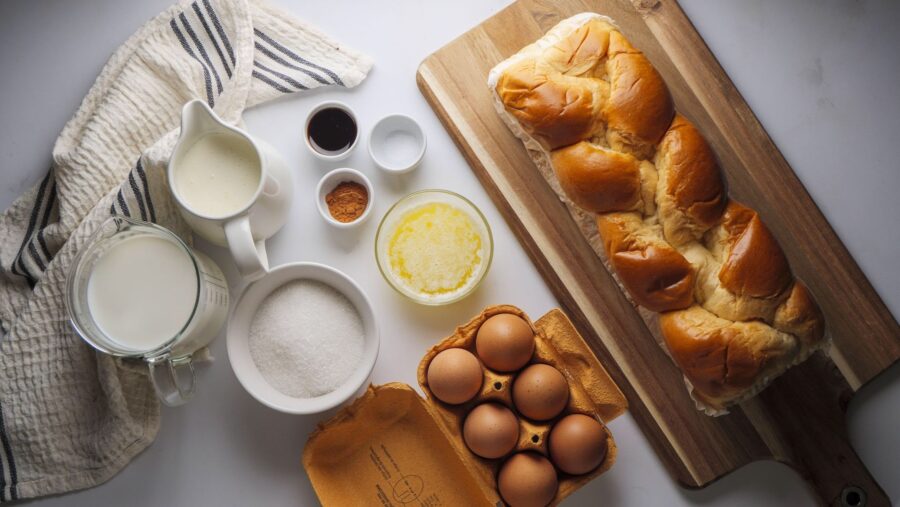 Baking ingredients for a bread recipe on wooden board.