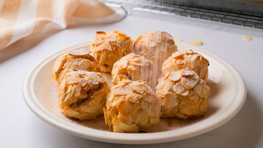 Traditional Italian Almond cookies on a plate, dusted with powdered sugar.