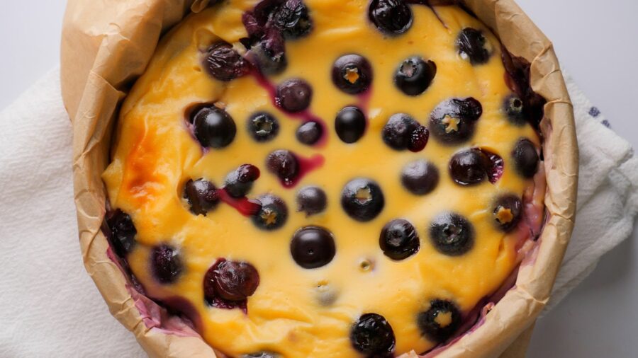 Homemade Blueberry yogurt cake on a parchment-lined plate.