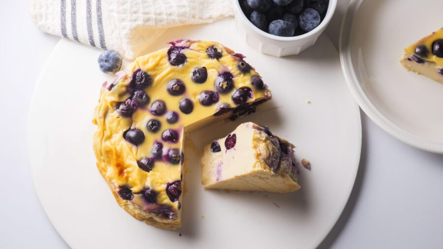 moist blueberry yogurt cake slice on a white plate.