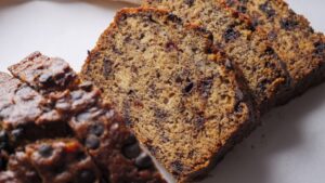 Sliced chocolate chip banana bread on a white background.
