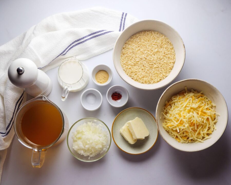 Ingredients for Cheesy Rice placed on a white kitchen counter