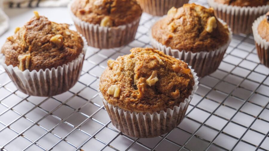 Freshly baked banana muffins cooling on a wire rack.