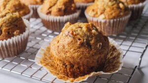Freshly baked banana nut muffins cooling on rack.