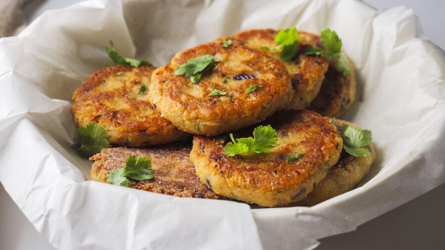 Golden brown chickpea patties garnished with fresh cilantro leaves.
