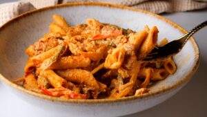 Creamy Jamaican rasta pasta with roasted vegetables.