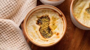 Turkish rice pudding with pistachio topping in a ramekin.