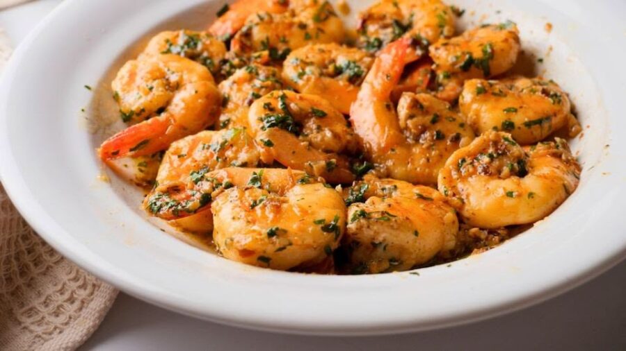 Garlic butter shrimp scampi served in a white bowl.