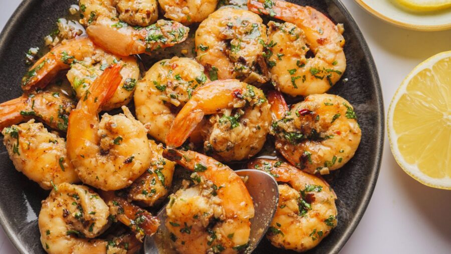 Lemon garlic shrimp scampi with herbs on a plate.