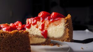 Strawberry cheesecake slice on a platter.