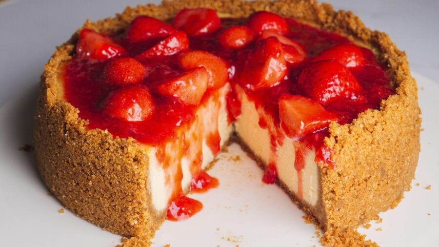 Strawberry cheesecake with Digestive biscuits crust slice missing.