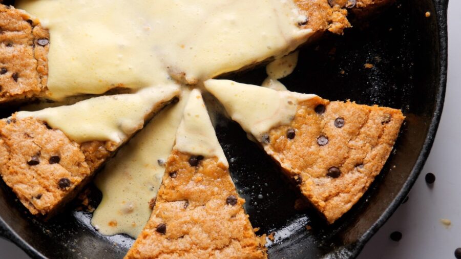 Chocolate chip skillet cookie with creamy topping.