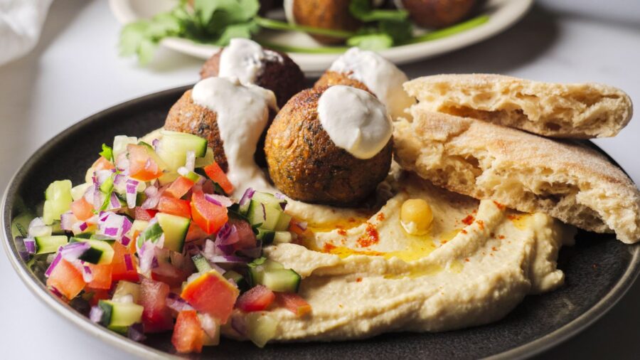 Fresh falafel with hummus, salad, and pita bread.