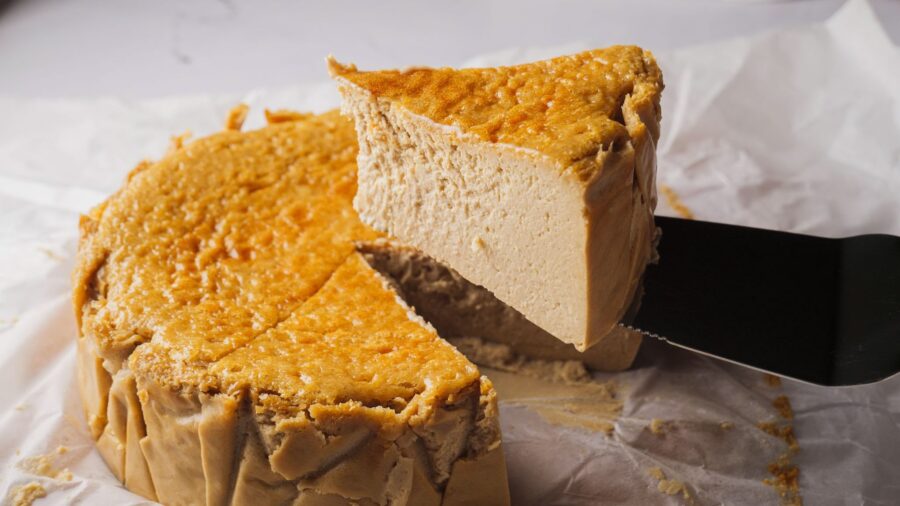 Creamy brown coffee cheesecake slice on parchment paper.