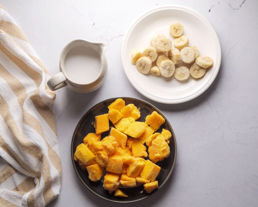 Mango Ice Cream Recipe Ingredients on a white kitchen counter