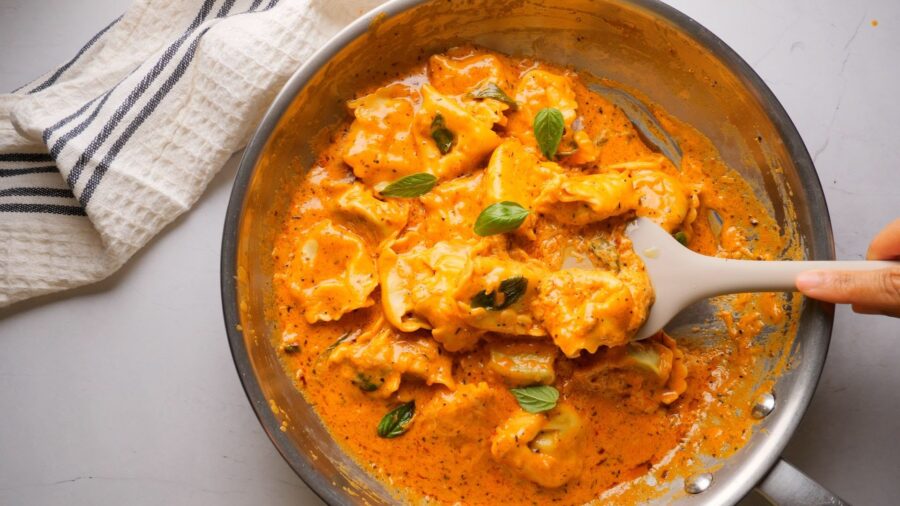 Creamy Tortellini Pasta in a pan with a spatula