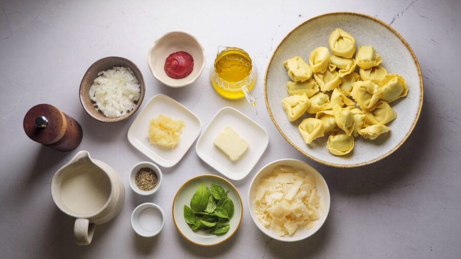 Creamy Tortellini Pasta Ingredients placed on a white kitchen counter